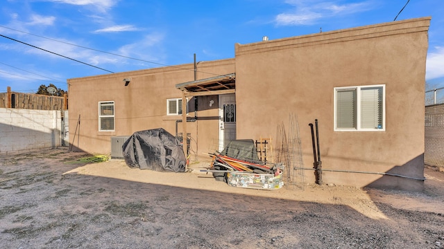 rear view of property featuring central AC unit