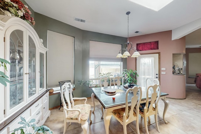 dining space with a chandelier