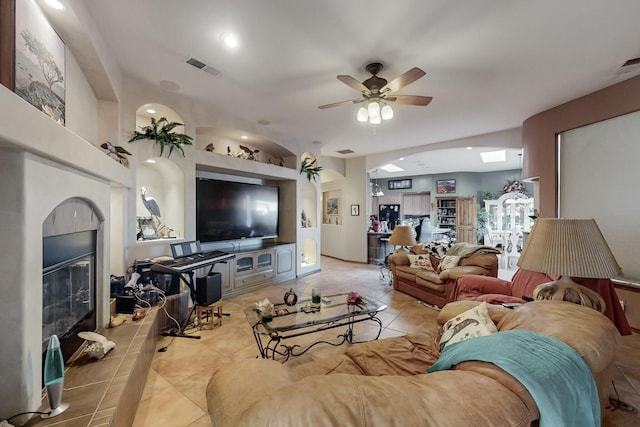 tiled living room featuring ceiling fan