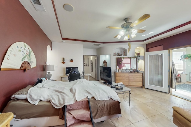 tiled bedroom featuring ensuite bath and ceiling fan