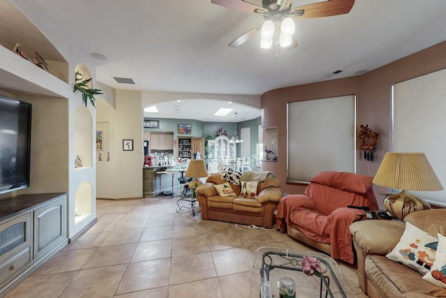 living room featuring light tile patterned floors and ceiling fan