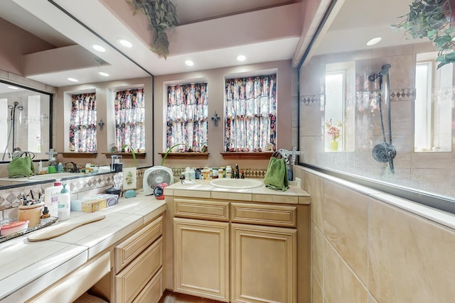 bathroom with vanity and a tile shower