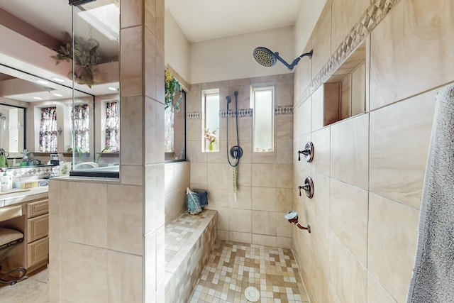 bathroom featuring vanity and a tile shower