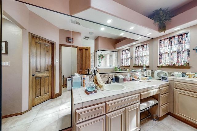 bathroom with tile patterned flooring and vanity