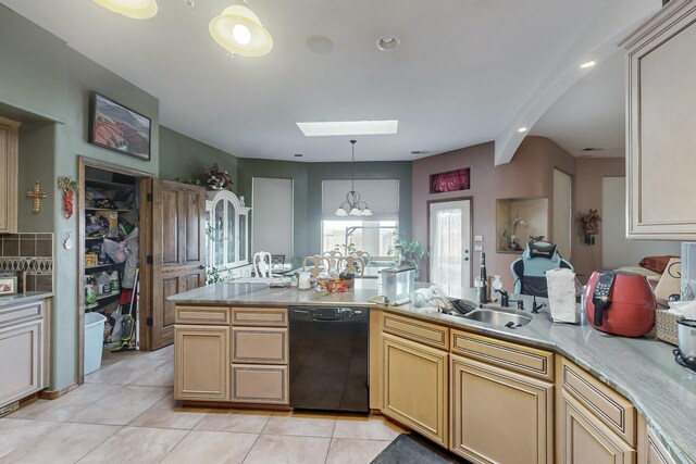 kitchen featuring a skylight, decorative light fixtures, black dishwasher, and light tile patterned floors