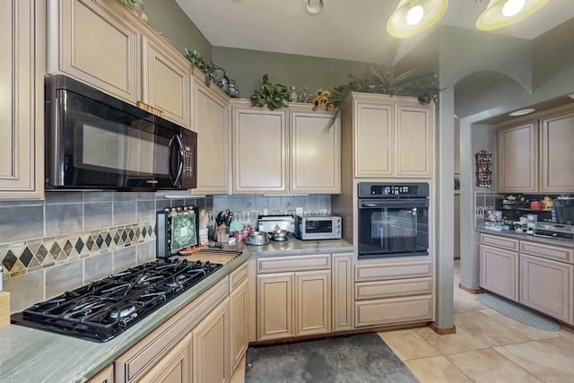 kitchen featuring light tile patterned flooring, decorative backsplash, and black appliances