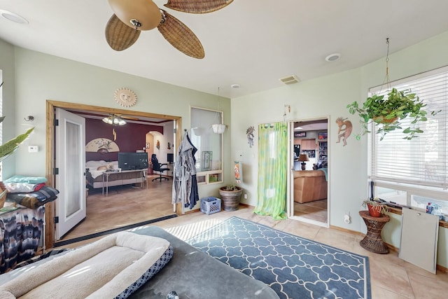 tiled bedroom with ceiling fan