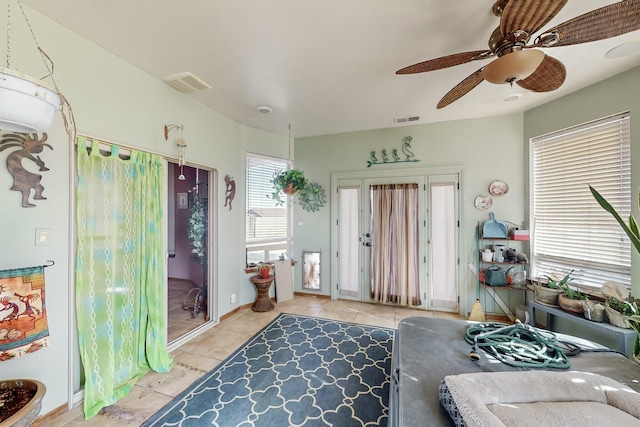 tiled living room with ceiling fan