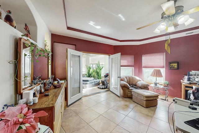 interior space with french doors, ceiling fan, a healthy amount of sunlight, and light tile patterned floors