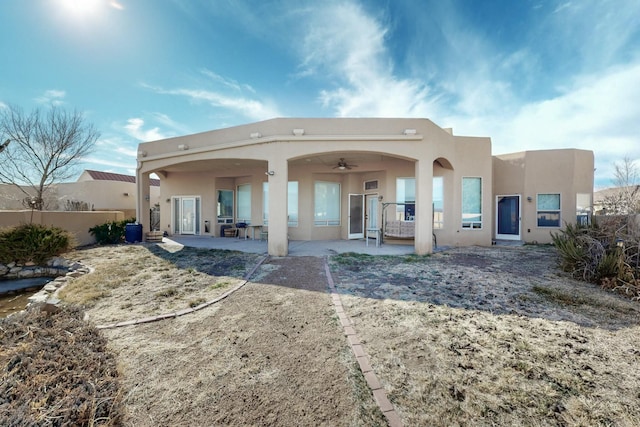 back of property with a patio area and ceiling fan