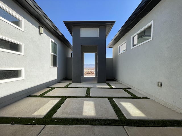 entrance to property featuring a patio