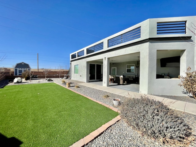 back of house with a patio and a yard