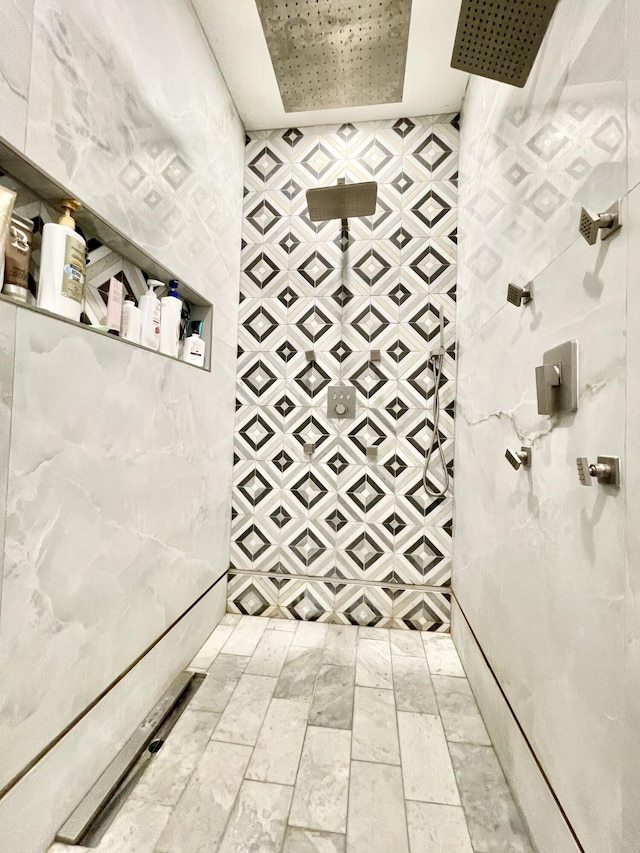 bathroom featuring a tray ceiling and walk in shower