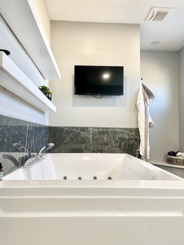 bathroom featuring a tub to relax in