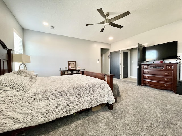 carpeted bedroom featuring a textured ceiling and ceiling fan