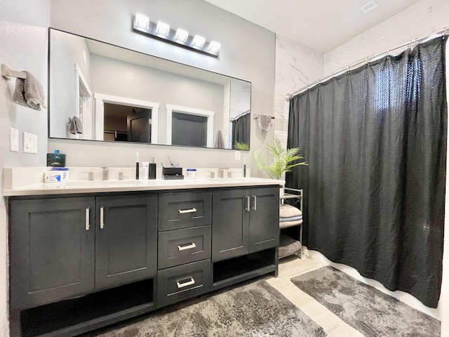 bathroom featuring vanity and curtained shower