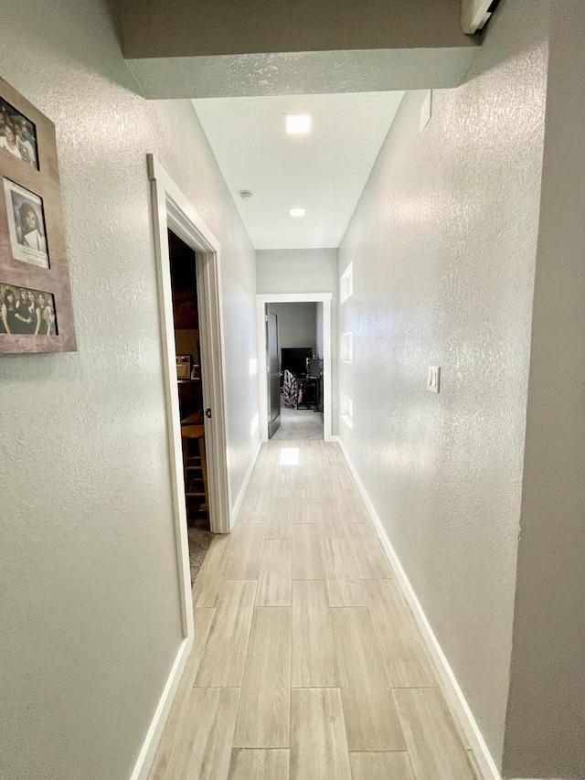 hallway with light hardwood / wood-style flooring