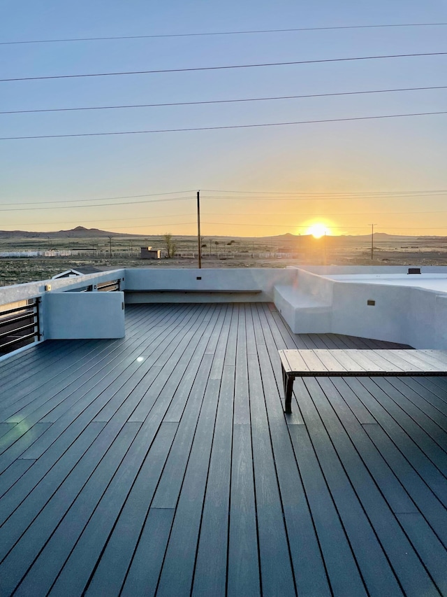 deck at dusk featuring a mountain view