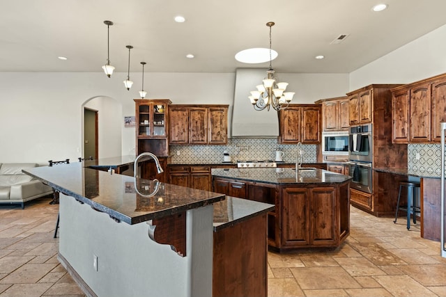 kitchen featuring a large island, hanging light fixtures, and stainless steel appliances