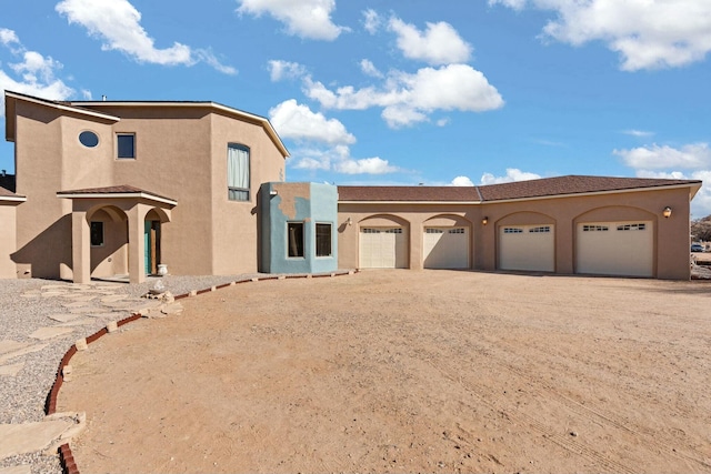 mediterranean / spanish-style home with a garage