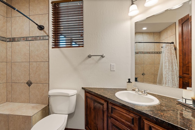 bathroom with vanity, curtained shower, and toilet