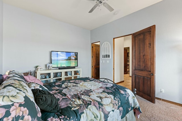 bedroom featuring light carpet and ceiling fan