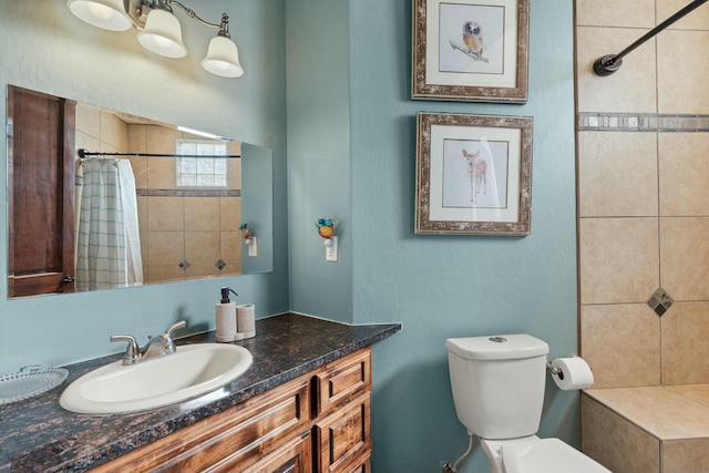 bathroom with vanity, walk in shower, and toilet