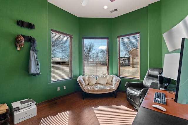 home office with dark hardwood / wood-style flooring and ceiling fan