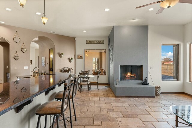 dining space featuring ceiling fan and sink