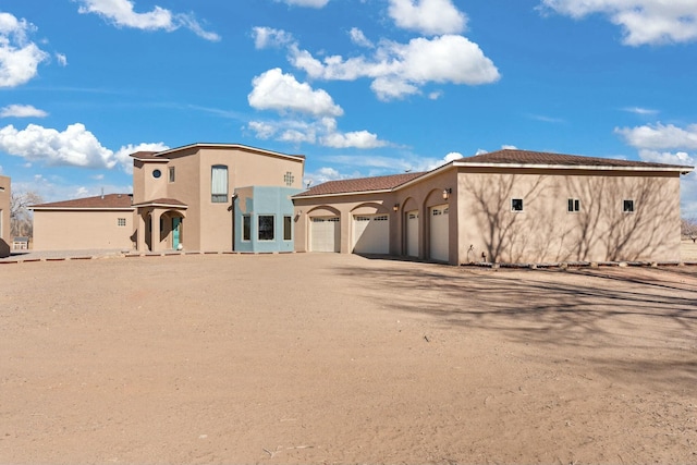 mediterranean / spanish house with a garage