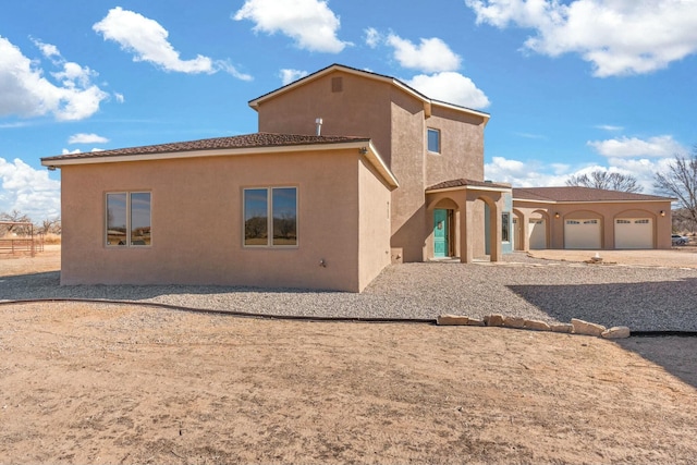 rear view of house featuring a garage