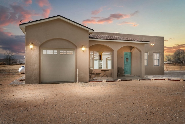 mediterranean / spanish house featuring a garage