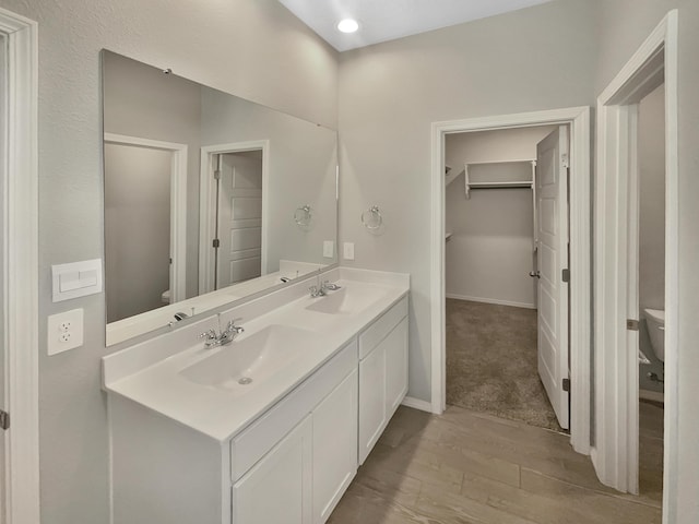 bathroom featuring vanity, toilet, and hardwood / wood-style floors