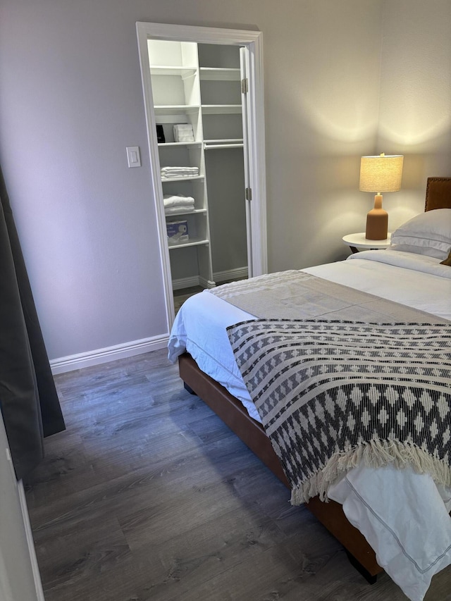 bedroom featuring dark wood-type flooring and a closet