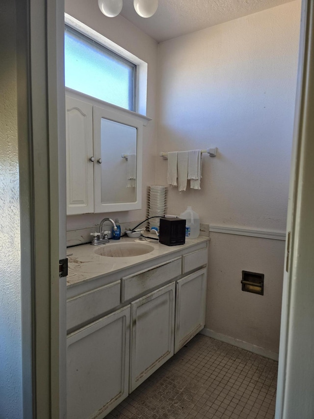 bathroom with vanity and a textured ceiling