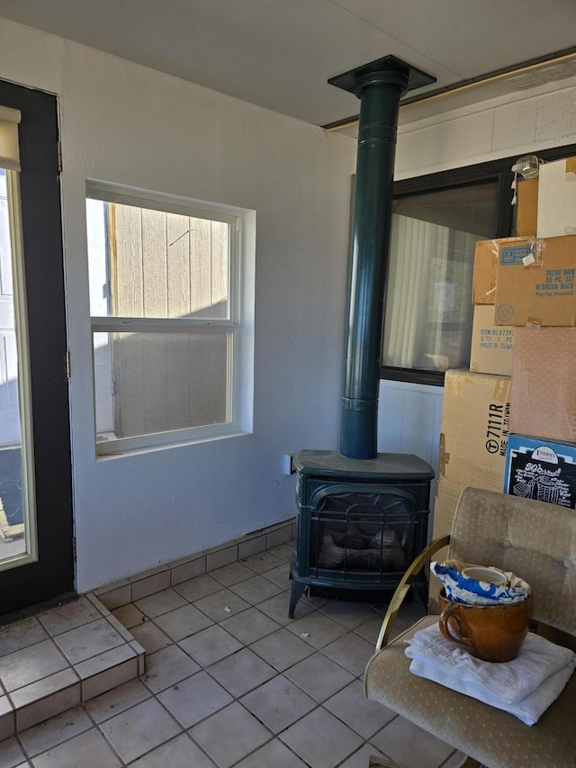 tiled living room with a wood stove