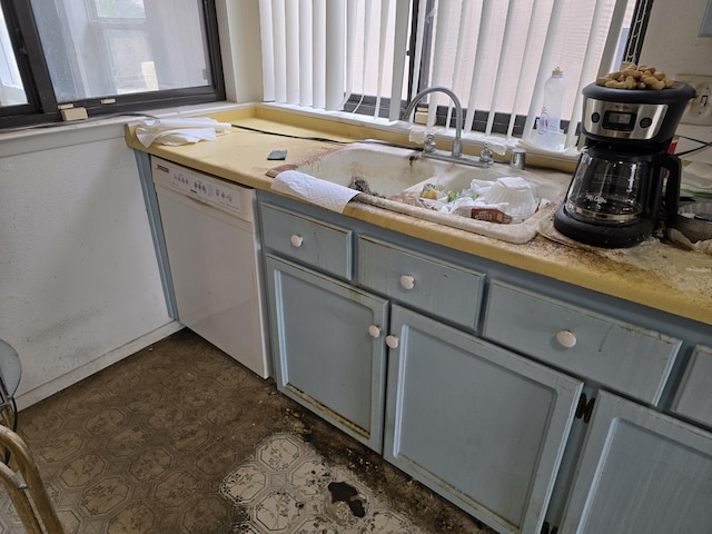 kitchen with white dishwasher, sink, and gray cabinetry