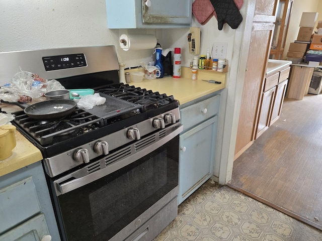 kitchen with gray cabinets and stainless steel gas range