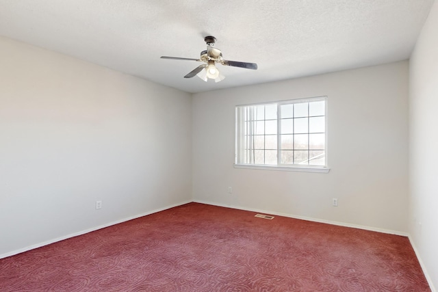 unfurnished room with ceiling fan, carpet, and a textured ceiling