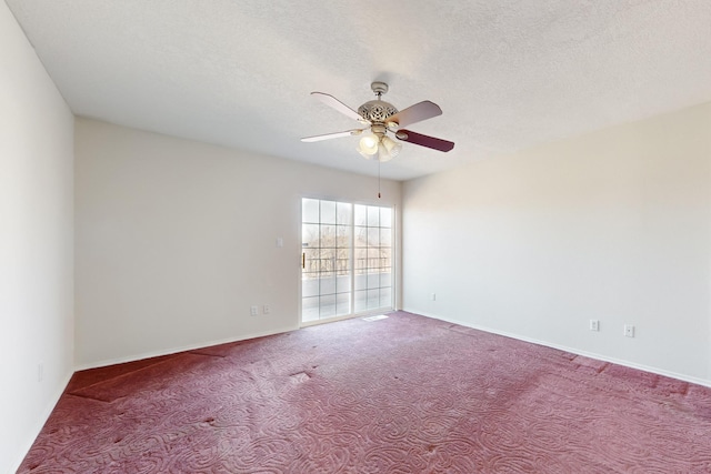 carpeted empty room with ceiling fan and a textured ceiling