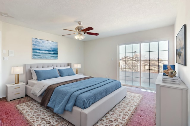 carpeted bedroom featuring ceiling fan, a textured ceiling, and access to outside