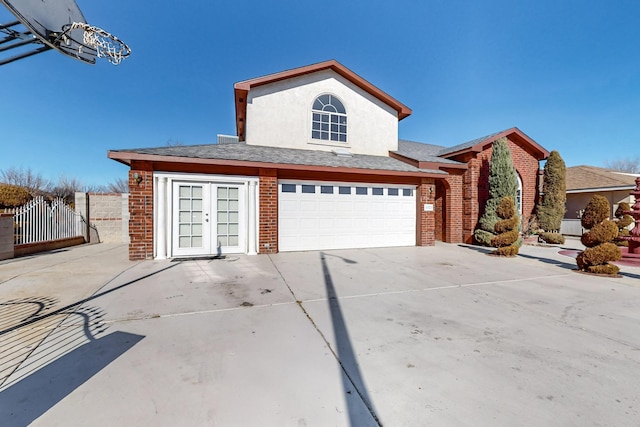 view of property featuring french doors and a garage