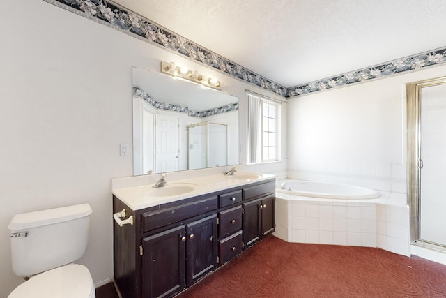 full bathroom featuring vanity, a textured ceiling, independent shower and bath, and toilet