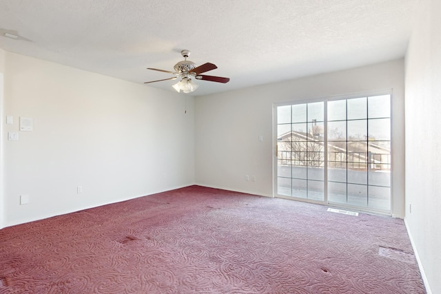 spare room with ceiling fan, light colored carpet, and a textured ceiling