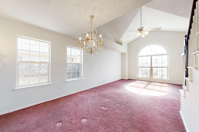 spare room with ceiling fan with notable chandelier, vaulted ceiling, and carpet flooring