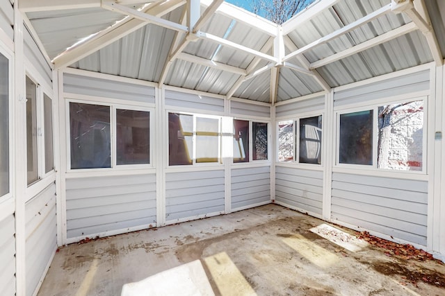 unfurnished sunroom featuring vaulted ceiling