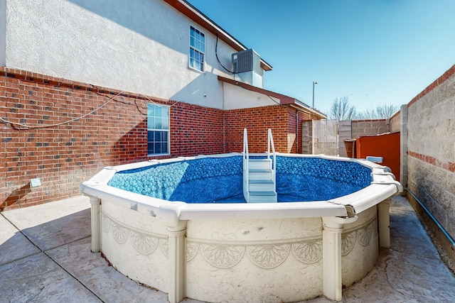 view of pool featuring central AC unit