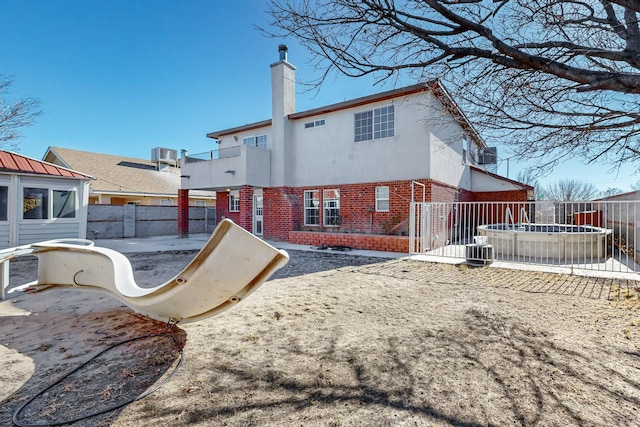 rear view of property with a balcony, cooling unit, and a patio area