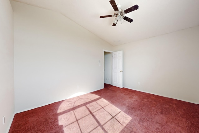 empty room featuring lofted ceiling, carpet floors, and ceiling fan