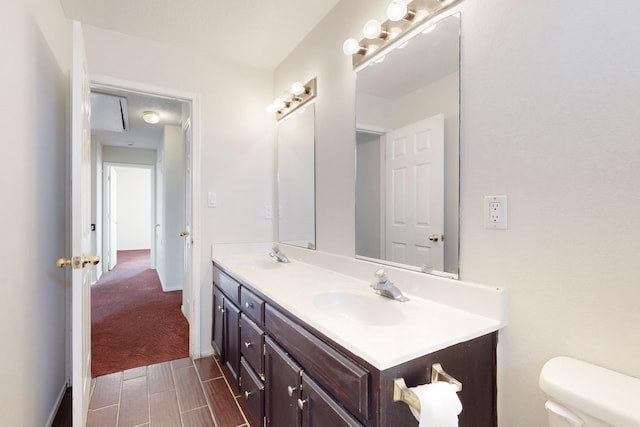 bathroom featuring vanity and toilet